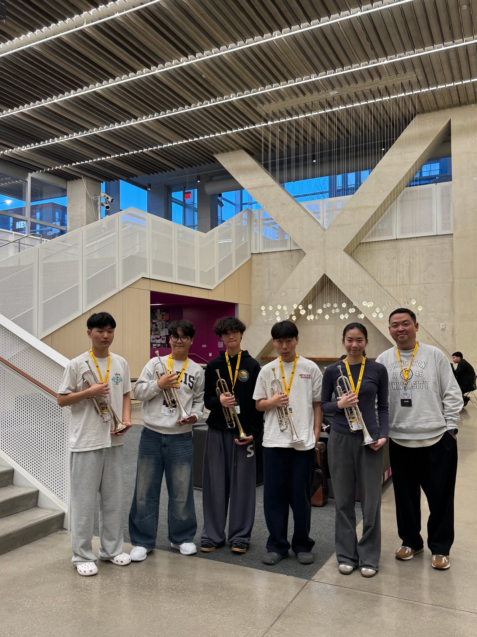 Students and Prof. Kim with trumpets in venue lobby
