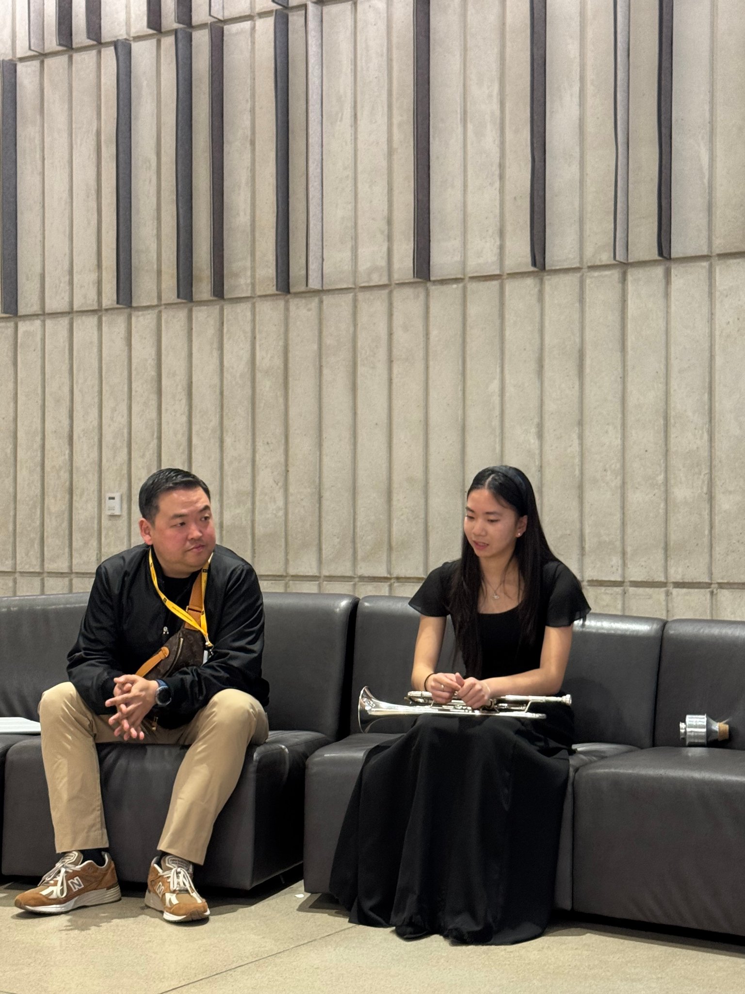 Prof. Kim coaching student backstage before performance