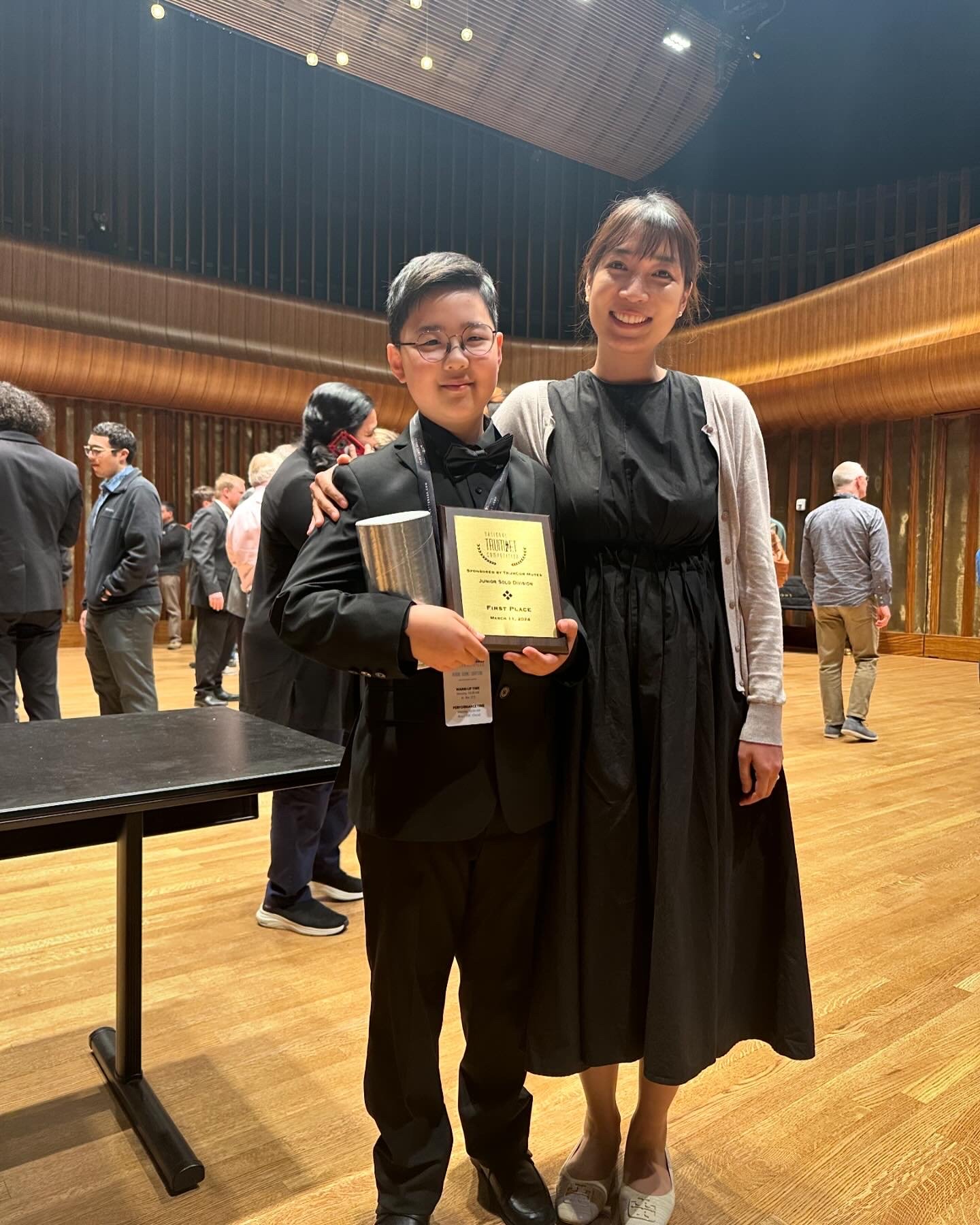Student and teacher celebrating with NTC First Place award in concert hall