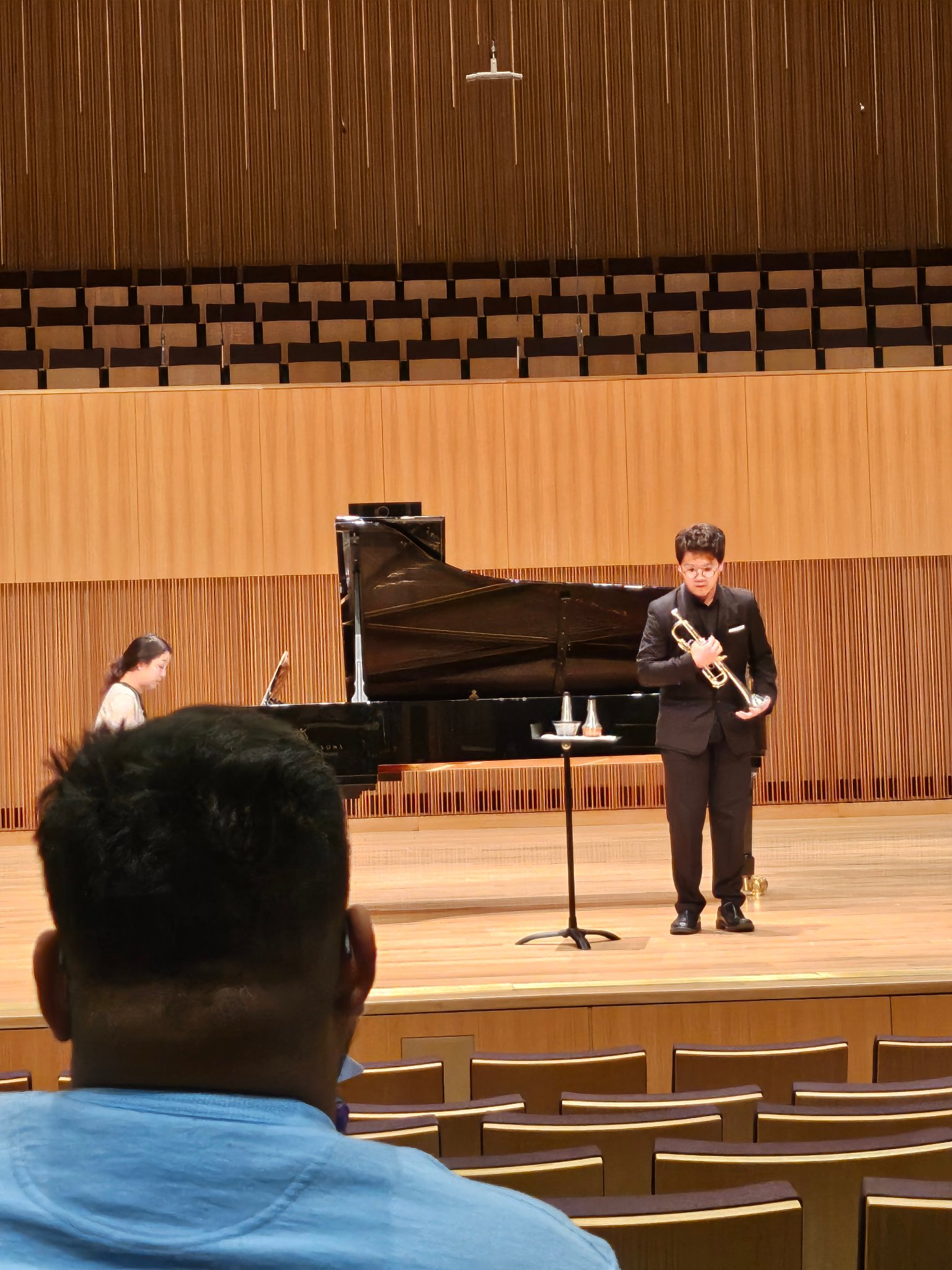 Student performing trumpet on stage with piano accompanist at NTC 2025