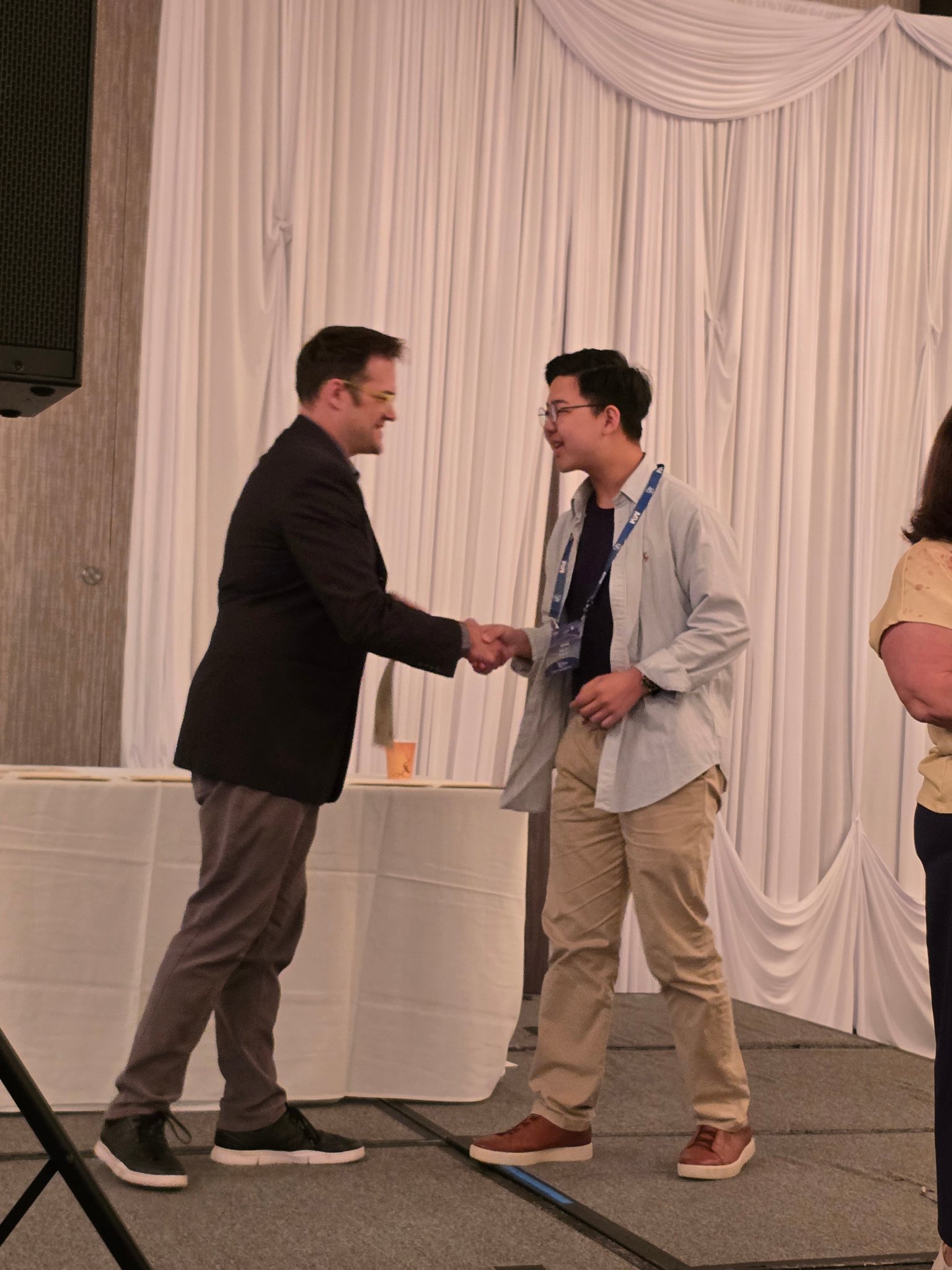 Student receiving award handshake on stage at ITG 2026