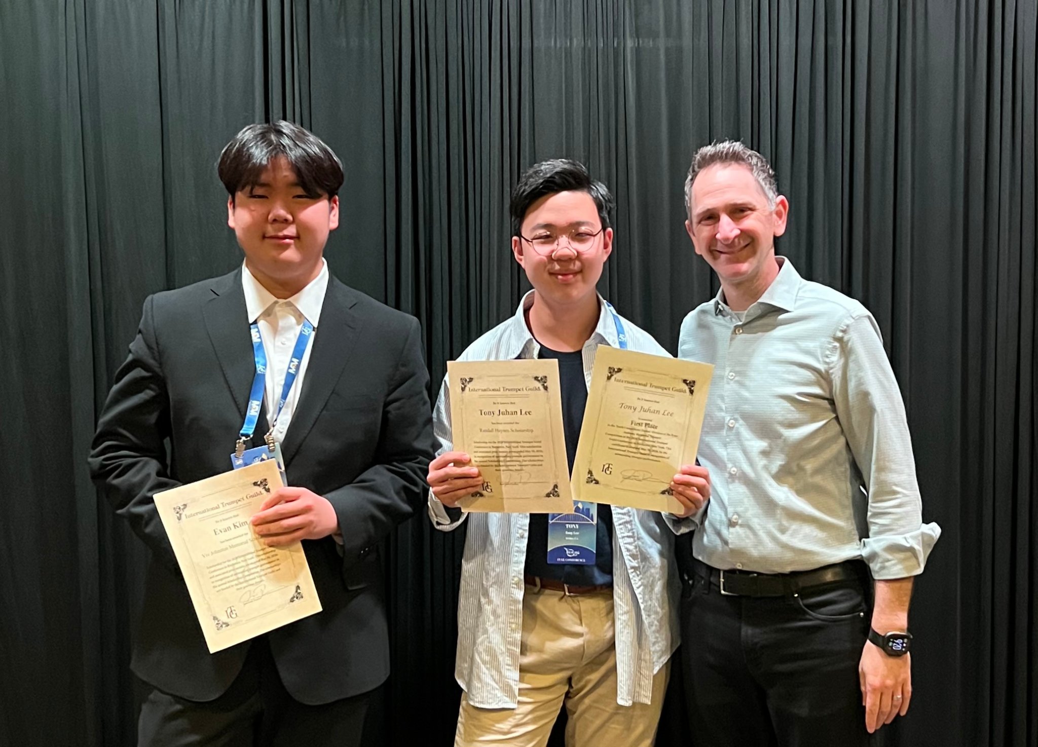 Evan Kim and Tony Juhan Lee holding ITG certificates with faculty member
