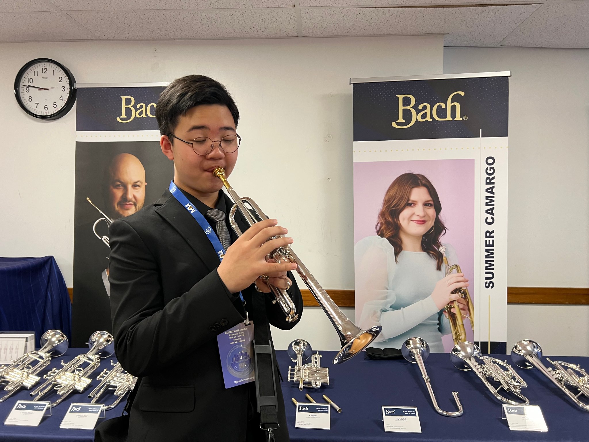 Student playing Bach trumpet at ITG exhibit hall