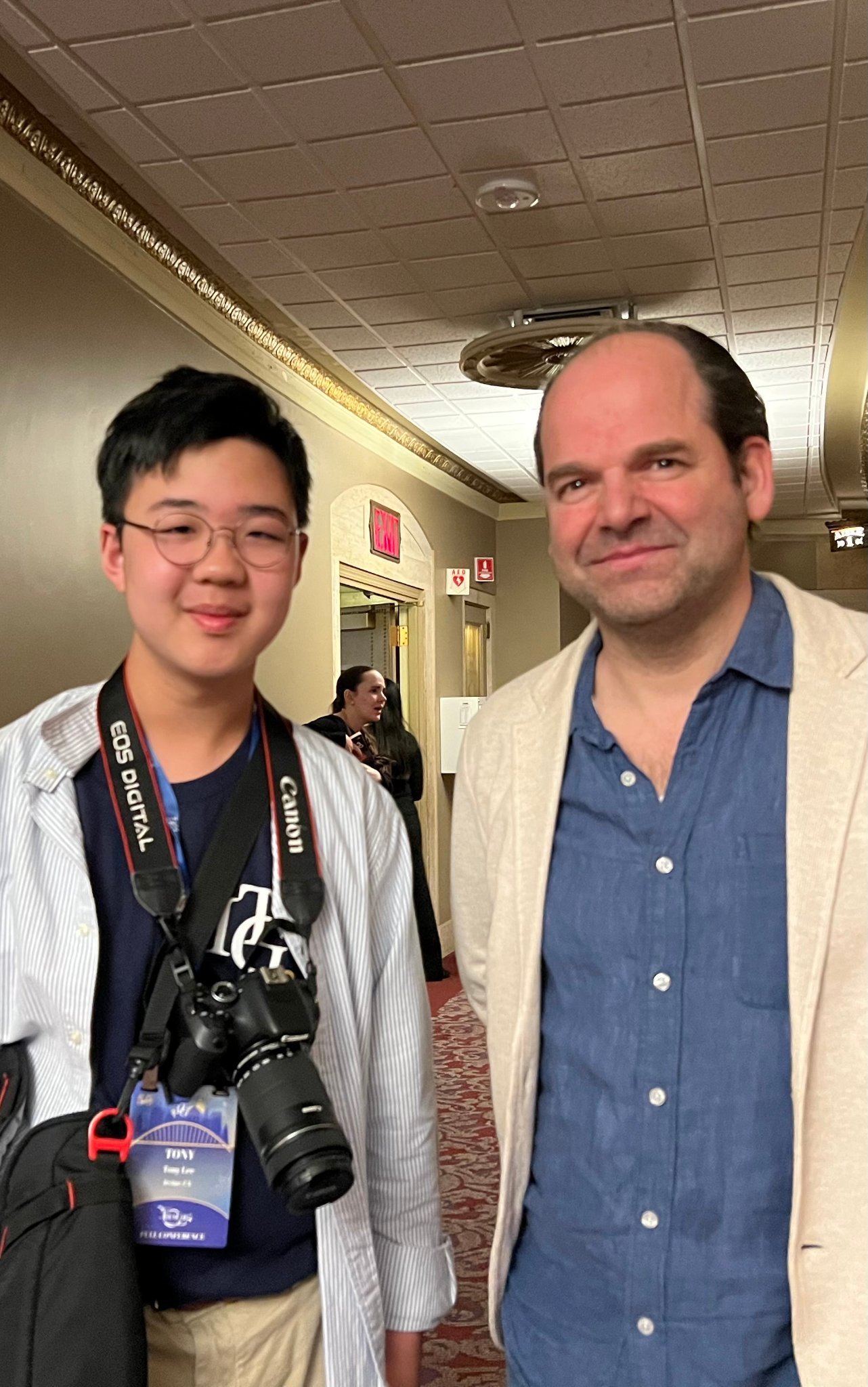 Student with trumpet artist in hotel corridor at ITG 2026