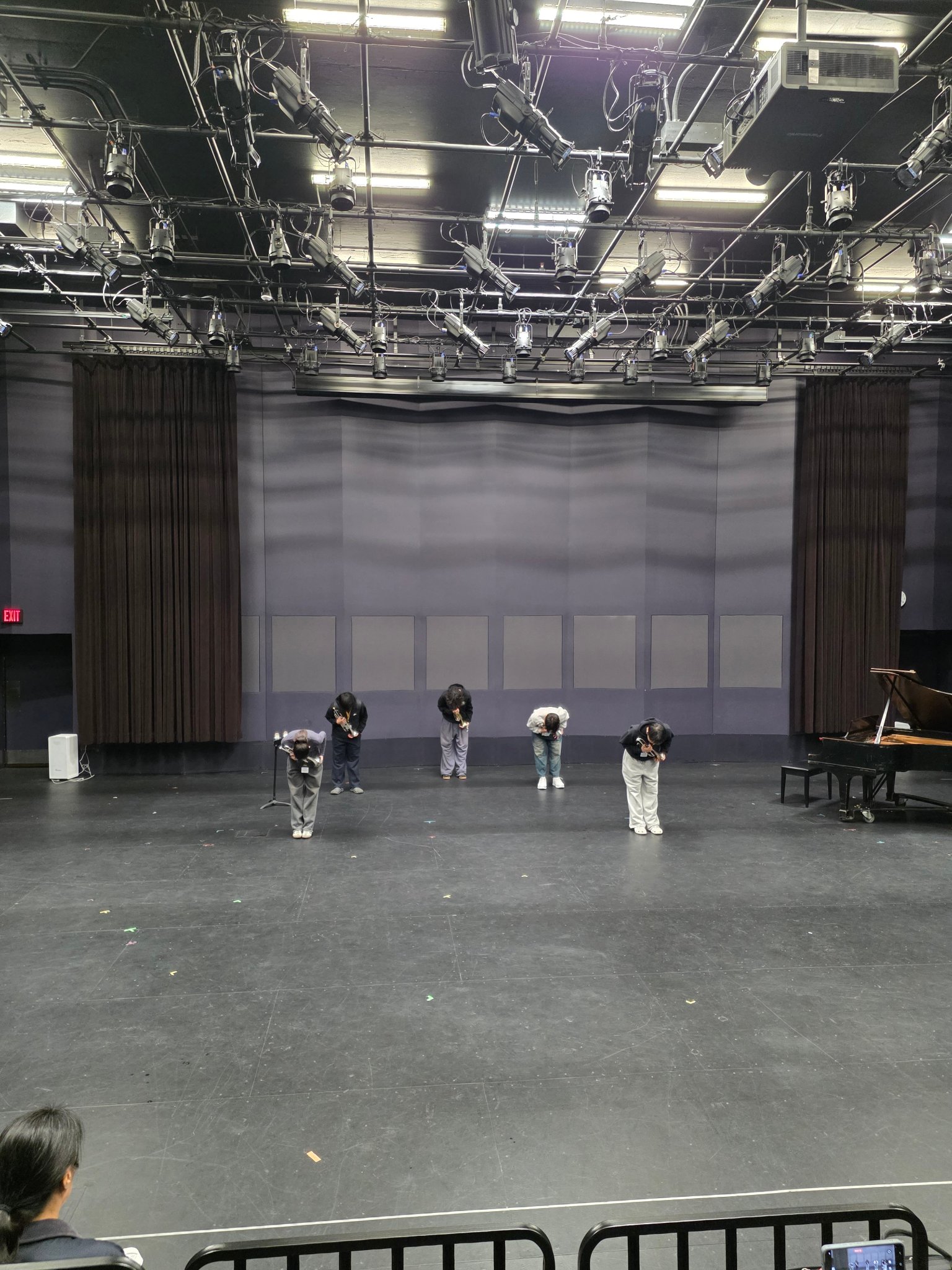 Students bowing on stage after performance