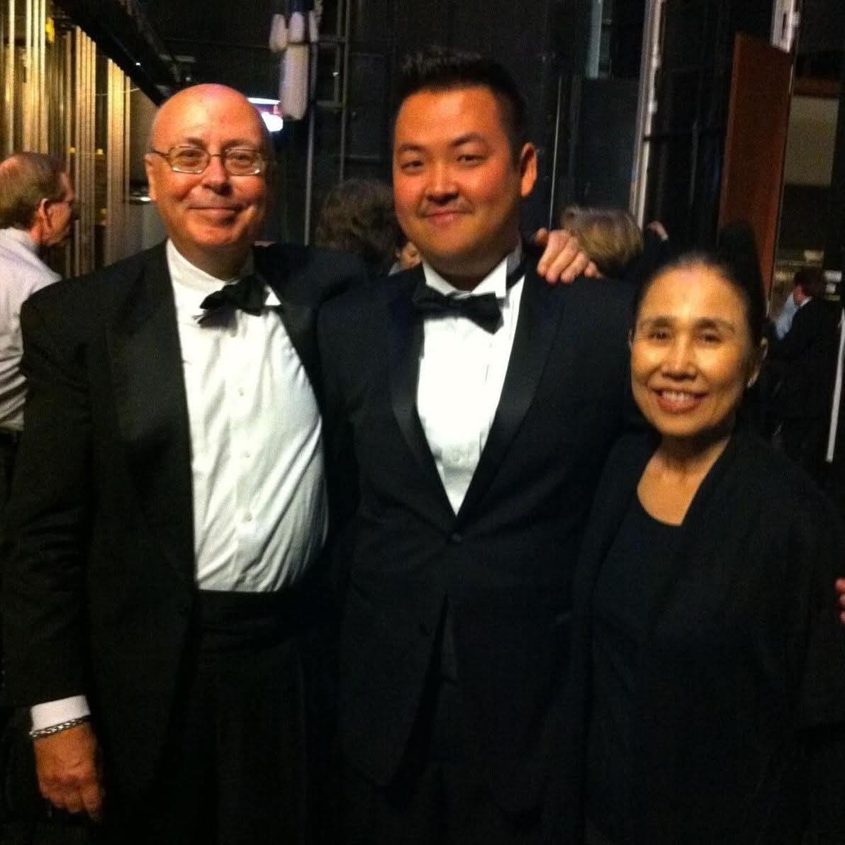 Matthew Kim with colleagues in formal attire after concert