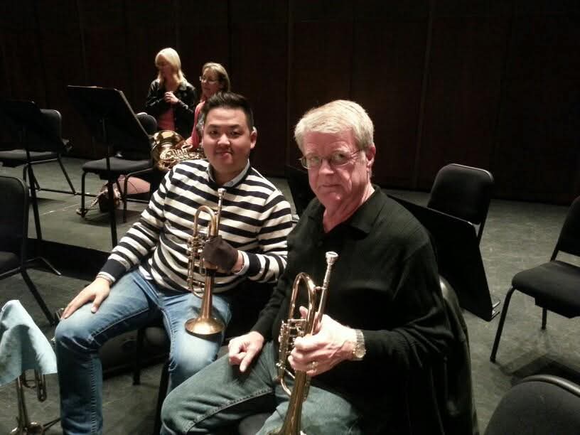 Matthew Kim and mentor holding trumpets after rehearsal