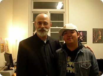 Matthew Kim with trumpet player in office