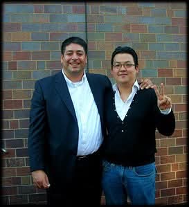 Matthew Kim with trumpet artist outdoors